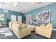 Bright and spacious community room with comfortable seating and a large bookshelf at 241 Riverside Drive # 409, Daytona Beach, FL 32117