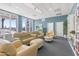 Relaxing community room with comfortable seating, bookshelves, and large windows at 241 Riverside Drive # 409, Daytona Beach, FL 32117