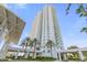 High-rise building exterior with palm trees and modern architecture at 241 Riverside Drive # 409, Daytona Beach, FL 32117