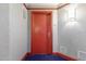 Residential hallway with red door and blue carpet at 241 Riverside Drive # 409, Daytona Beach, FL 32117