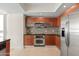 Modern kitchen with stainless steel appliances and wood cabinetry at 241 Riverside Drive # 409, Daytona Beach, FL 32117