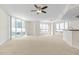 Bright living room with large windows, carpet and ceiling fan at 241 Riverside Drive # 409, Daytona Beach, FL 32117