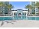 Relaxing pool area with palm trees and a view of the building at 241 Riverside Drive # 409, Daytona Beach, FL 32117