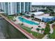 Aerial view of community pool and clubhouse near waterfront at 241 Riverside Drive # 409, Daytona Beach, FL 32117