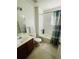 Clean bathroom with tub, shower, and updated vanity at 2600 Lodi Cir # 101, Kissimmee, FL 34746