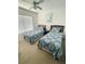Two twin beds with matching bedding in a bright bedroom at 2600 Lodi Cir # 101, Kissimmee, FL 34746