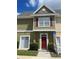 Inviting exterior of townhome with red door and landscaping at 2600 Lodi Cir # 101, Kissimmee, FL 34746