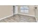 Spacious bedroom with wood-look flooring and large window at 2718 Se 45Th Ave, Ocala, FL 34480