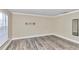 Simple bedroom with wood-look floors and a large window at 2718 Se 45Th Ave, Ocala, FL 34480
