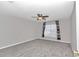 Spacious bedroom with ceiling fan, gray carpet, and window coverings at 2718 Se 45Th Ave, Ocala, FL 34480