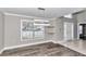 Dining room with wood-look floors, large window, and chandelier at 2718 Se 45Th Ave, Ocala, FL 34480