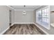 Simple dining room with wood-look floors and a large window at 2718 Se 45Th Ave, Ocala, FL 34480
