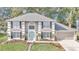 Two-story house with gray siding, black shutters, and a teal front door at 2718 Se 45Th Ave, Ocala, FL 34480