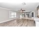 Bright living room with wood-look flooring and view of kitchen at 2718 Se 45Th Ave, Ocala, FL 34480