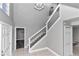 Modern staircase with metal railing in a neutral-toned entryway at 2718 Se 45Th Ave, Ocala, FL 34480