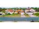 House with orange roof and yellow walls, next to other houses at 308 Robin Rd, Davenport, FL 33896