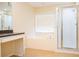 Bathroom features garden tub, shower, and vanity at 308 Robin Rd, Davenport, FL 33896
