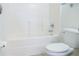 Clean bathroom with a bathtub, toilet and tiled walls at 308 Robin Rd, Davenport, FL 33896