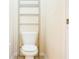 Small bathroom with toilet and shelving unit at 308 Robin Rd, Davenport, FL 33896