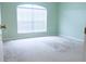 Bright bedroom with carpeted floor and large window at 308 Robin Rd, Davenport, FL 33896