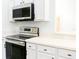 Modern kitchen with stainless steel range and microwave at 308 Robin Rd, Davenport, FL 33896