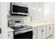Modern kitchen with stainless steel range and microwave at 308 Robin Rd, Davenport, FL 33896