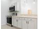 Updated kitchen featuring stainless steel appliances and light cabinets at 308 Robin Rd, Davenport, FL 33896