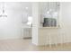 Open concept kitchen with light gray cabinets and stainless steel appliances at 308 Robin Rd, Davenport, FL 33896