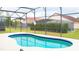 Screened-in pool with surrounding patio at 308 Robin Rd, Davenport, FL 33896