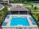 Community pool with plenty of lounge chairs and a covered area at 3332 Private Oak Dr, Apopka, FL 32703