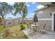 Small backyard with patio furniture and wooden fence at 430 Magpie Ct, Kissimmee, FL 34759