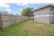 Side yard with wooden fence at 430 Magpie Ct, Kissimmee, FL 34759