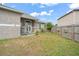 Fenced backyard with grassy area and patio at 430 Magpie Ct, Kissimmee, FL 34759