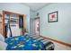 Bedroom with wood floors, mirrored closet doors, and access to another room at 430 Magpie Ct, Kissimmee, FL 34759