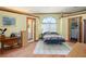 Cozy bedroom with wood floors, an arched window, and built-in closet at 430 Magpie Ct, Kissimmee, FL 34759