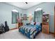 Spacious bedroom with wood floors, built in shelves, and large windows at 430 Magpie Ct, Kissimmee, FL 34759