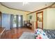 Bedroom with wood floors, sliding glass doors to a patio, and a full bathroom at 430 Magpie Ct, Kissimmee, FL 34759