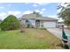Charming one-story house with gray siding, a gray door, and a well-manicured lawn at 430 Magpie Ct, Kissimmee, FL 34759