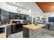Modern kitchen with dark cabinetry, wood countertop island, and stainless steel appliances at 430 Magpie Ct, Kissimmee, FL 34759