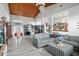 Open floor plan with a sectional sofa, hardwood floors, and vaulted ceilings at 430 Magpie Ct, Kissimmee, FL 34759