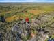 Aerial view showing property location nestled in a wooded area near a road at 4390 Saxon Dr, New Smyrna Beach, FL 32169