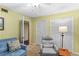 Bright den with comfortable seating and built-in shelving at 4390 Saxon Dr, New Smyrna Beach, FL 32169