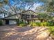 House exterior featuring brick driveway, stone accents, and lush landscaping at 4390 Saxon Dr, New Smyrna Beach, FL 32169