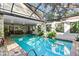 Enclosed pool area with seating and access to a patio at 4390 Saxon Dr, New Smyrna Beach, FL 32169