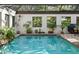 Indoor pool area with lush plants and natural light at 4390 Saxon Dr, New Smyrna Beach, FL 32169