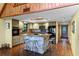 Galley kitchen with granite counters, wood cabinets, and modern appliances at 4390 Saxon Dr, New Smyrna Beach, FL 32169