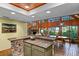 Kitchen with granite island, view of dining area and nature at 4390 Saxon Dr, New Smyrna Beach, FL 32169