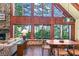 Bright living room with wall of windows and dining area at 4390 Saxon Dr, New Smyrna Beach, FL 32169