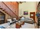 Spacious living room with a stone fireplace and large windows at 4390 Saxon Dr, New Smyrna Beach, FL 32169
