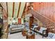 Spacious living room with wood-paneled walls and a view of the kitchen at 4390 Saxon Dr, New Smyrna Beach, FL 32169